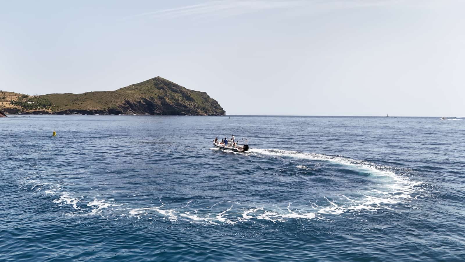 Boat sailing the Cap de Creus coves from Roses, Costa Brava